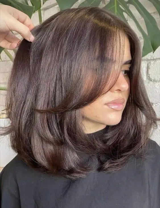Medium length chocolate brown hair with layers and a lot of volume is a stunning idea to rock, it looks elegant and stylish