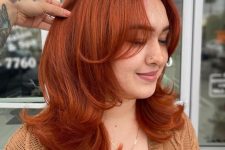 medium length hair, a butterfly haircut and a super bold copper color plus a lot of volume are a fantastic combo