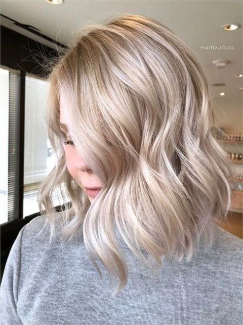 medium-length icy blonde hair with a bit of waves and volume is a stylish idea if you like cold shades of blonde