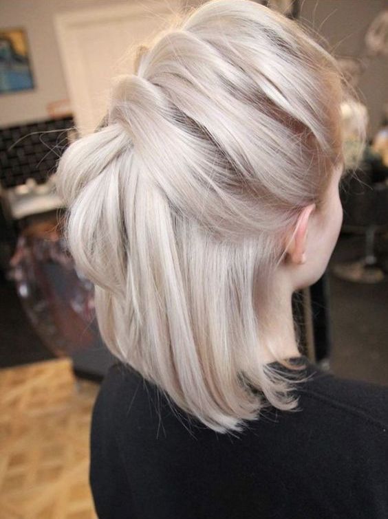 Medium length platinum blonde hair with a braid on top and straight hair down is a stylish and catchy idea