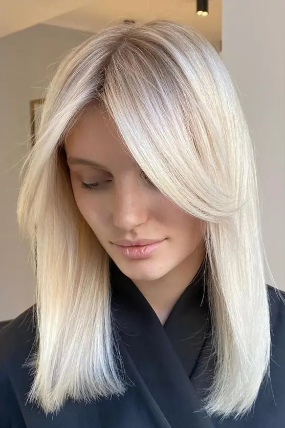 Medium length platinum blonde hair with middle part and side bangs framing the face is a lovely idea