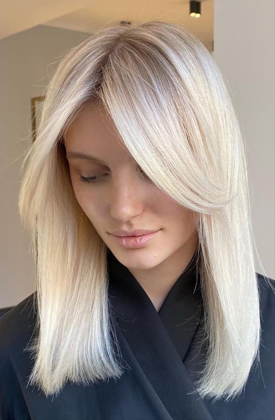 medium-length platinum blonde hair with middle part and side bangs framing the face is a lovely idea