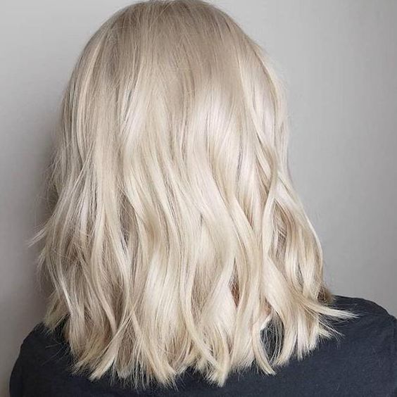 medium-length platinum blonde hair with waves and a bit of volume is always a beautiful and chic idea
