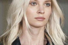 medium length platinum blonde hairstyle with a bit of layers and waves is a stylish solution with a catchy hair color