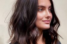 messy medium-length chocolate brown hair with a bit of volume and waves is a lovely and relaxed solution