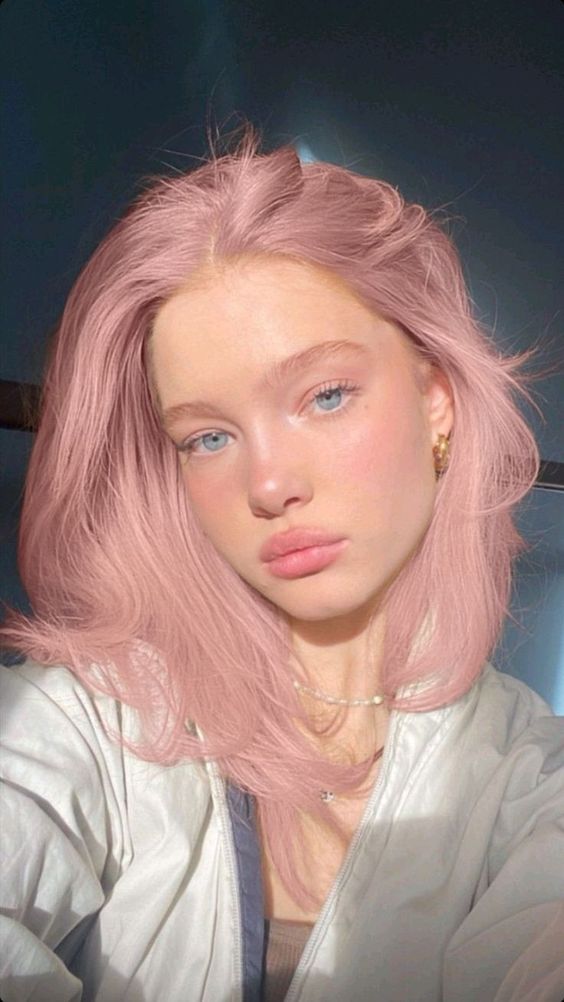 Pink medium length hair with a lot of volume and texture looks absolutely doll like and incredibly cool