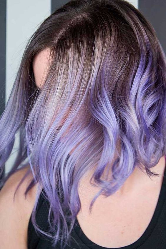 Superb medium length hair with lilac and purple ombre and a darker root plus waves is amazing for anyone