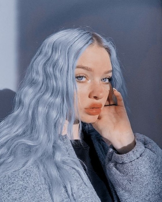 textural and wavy pastel blue hair that perfectly echoes with the blue eyes and accents them a lot