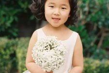 waves down, side parting and a white bow on one side are all your flower girl needs to look fantastic