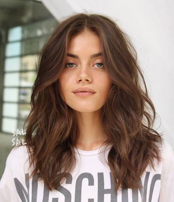 Wavy layered medium length hair in soft brown, with a lot of volume is a lovely idea to try