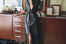 a beautiful black elather shirtdress of midi length, with short sleeves and black pumps for ultimately elegant look