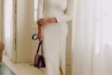 a beautiful midi sweater dress with a row of buttons and a slit, tan boots and a purple bag for a winter bridal shower