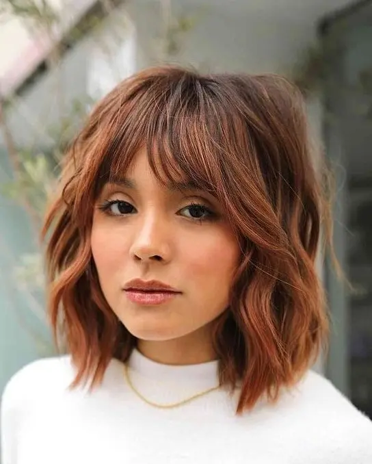 a beautiful red shaggy long bob with a darker brown root and choppy layers is amazing to try for the fall