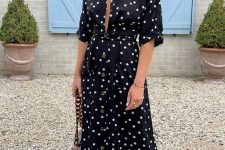 a black polka dot midi dress with a plunging neckline, a chic bag with chain and bold green shoes are a nice idea for a summer date