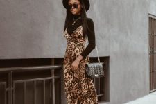 a black turtleneck, a leopard print slip dress, a black bag and ankle boots, a black hat for this fall