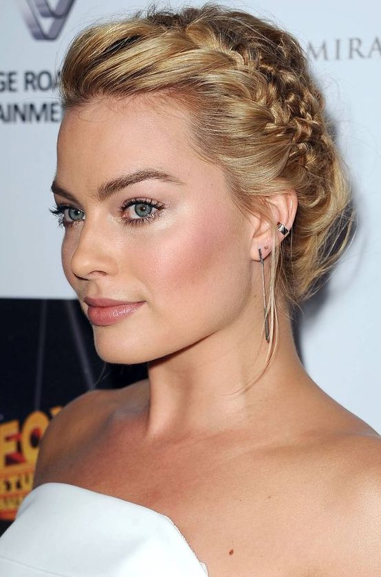 a braided updo with a volumetric top is a catchy and chic idea not only for the holidays but also for other occasions
