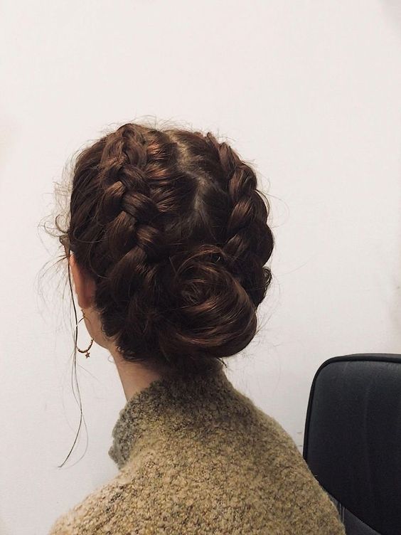 a braided updo with a wrapped bun and chunky braids on the sides of the head is a cool idea for the holidays