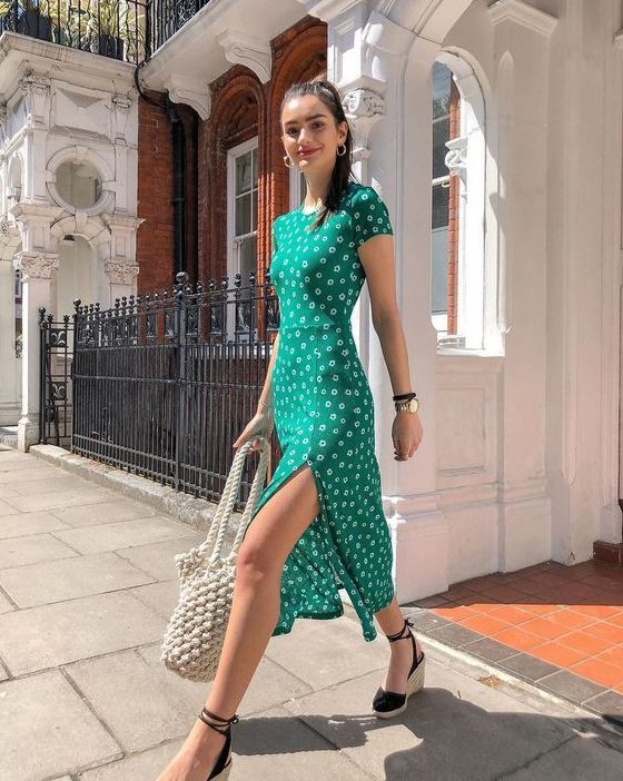 a bright green fitting midi dress with a high neckline, short sleeves and a side slit plus espadrilles and a woven bag