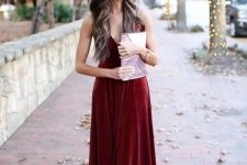 a burgundy velvet maxi dress with spaghetti straps, lilac shoes and a lilac clutch for a chic winter wedding guest look