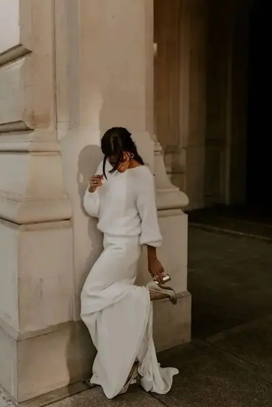 a casual look with a white fuzzy sweater and a maxi skirt with a train plus silver shoes is all cool
