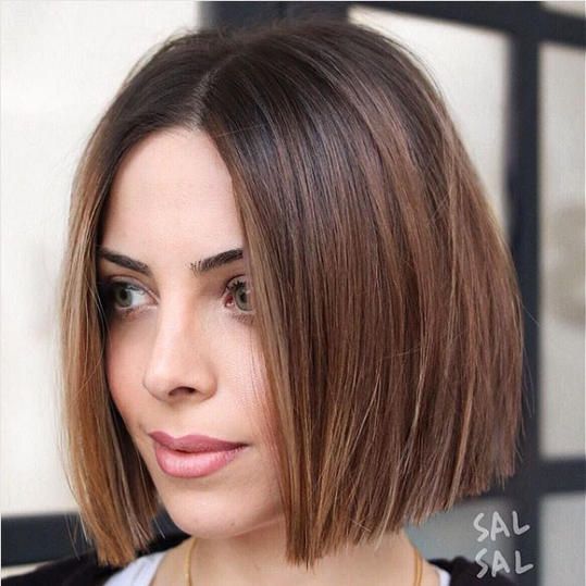 A chestnut chin length bob with a darker root and straight hair is a catchy and cool solution