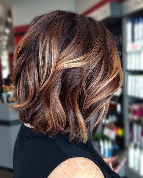 a chic and bold long bob in auburn and brown, with honey blonde balayage and waves is gorgeous