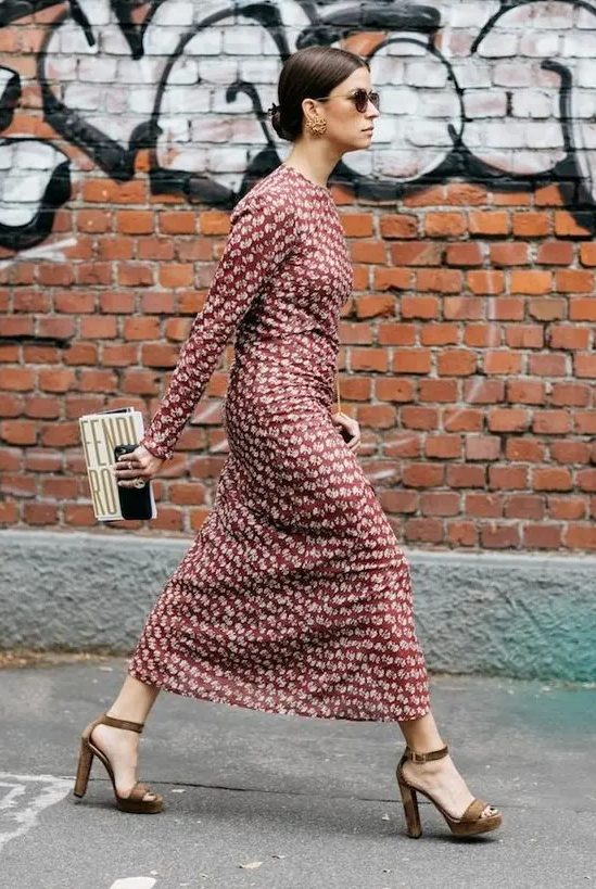 a chic burgundy printed midi dress with long sleeves, a high neckline, brown platform shoes and a whimsy clutch