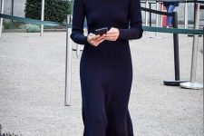 a chic winter look with an A-line knit black midi dress with a turtleneck and long sleeves plus black boots