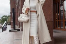 a cool bridal shower outfit with a crop top and a midi skirt, creamy boots, a coat, a bag are a chic look to try