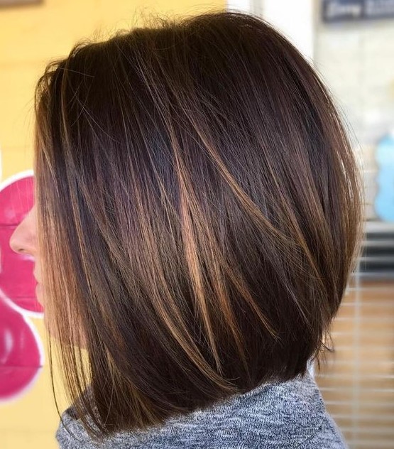 a dark brunette long bob with caramel balayage, such highlights give interest to the look