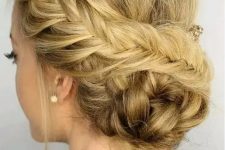 a fishtail side braided updo with a braided bun and some locks down is a creative idea for a boho look