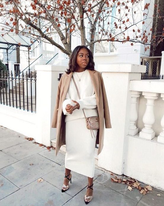 A gorgeous and luxurious look with a creamy co ord set with a midi skirt and a jumper, a tan coat, lace up shoes and a tan bag
