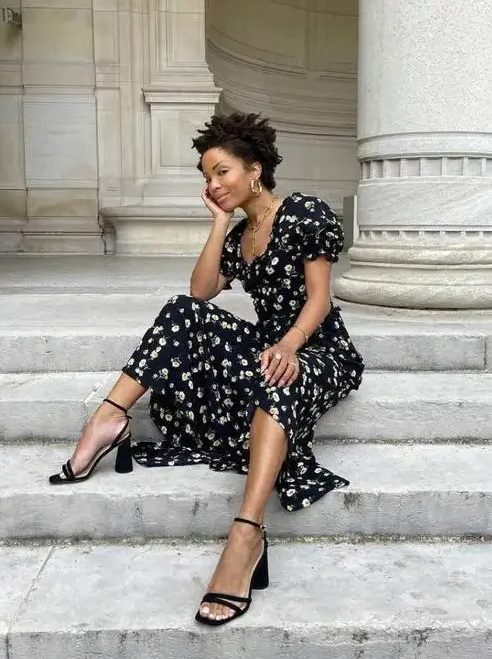 a gorgeous black and white floral midi dress with a square neckline and puff sleeves, black heels and statement jewelry
