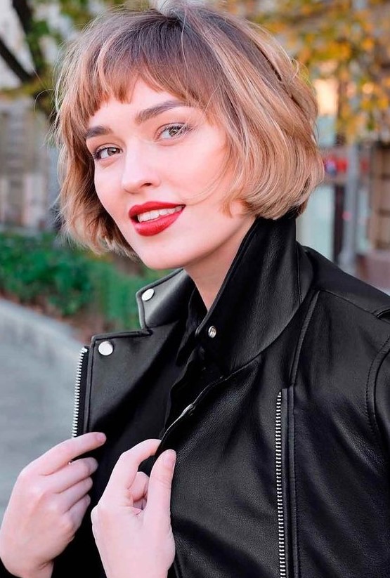 A jaw length brunette bob with blonde balayage and waves plus bangs is a catchy idea, which looks effortless