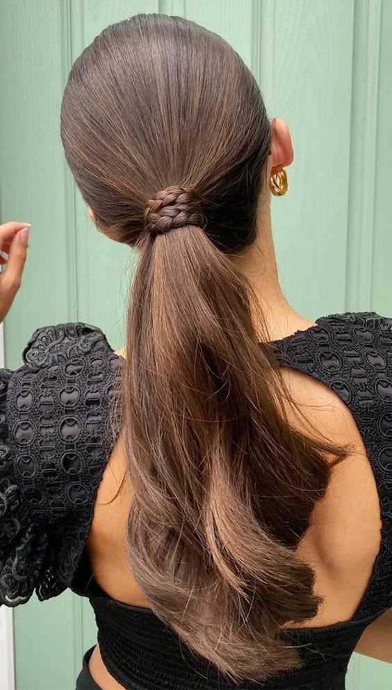 a modern ponytail wrapped with a braid, with a sleek top and waves down is amazing for a party