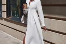 a plain white midi shirtdress with buttons, white flipflops with heels and a white bag for a summer bridal shower