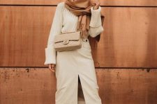 a pretty and casual winter bridal shower look with a chunky sweater, a midi skirt with a front slit, white boots, a tan bag and a brown scarf
