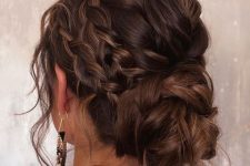 a pretty and messy braided low bun with twi side braids and hair down is a cool and catchy idea for a party look