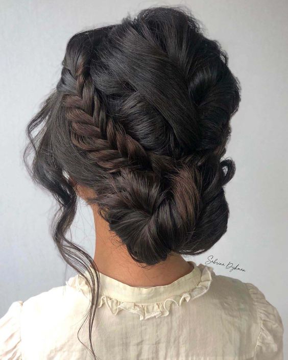 a pretty low twisted updo with a side fishtail braid and face-framing hair is cool