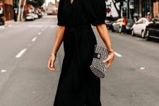 a refined black midi shirtdress with puff sleeves and a deep neckline, black shoes and a printed mini handbag