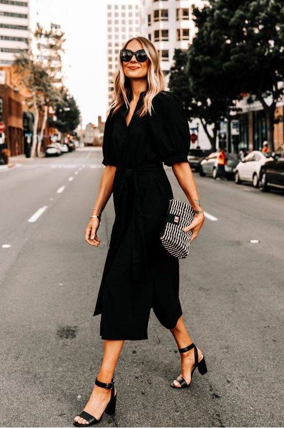 a refined black midi shirtdress with puff sleeves and a deep neckline, black shoes and a printed mini handbag