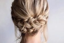a rustic low updo with a double braid and some locks down is a stylish idea for a catchy party look