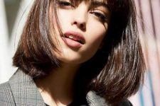 a shiny chestnut long bob with a classic fringe, with a lot of volume and curved ends is an elegant and timeless solution