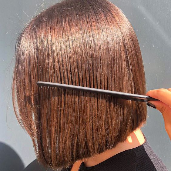 a shiny midi chestnut bob looks copper in the sun, it looks lovely and catchy and bold
