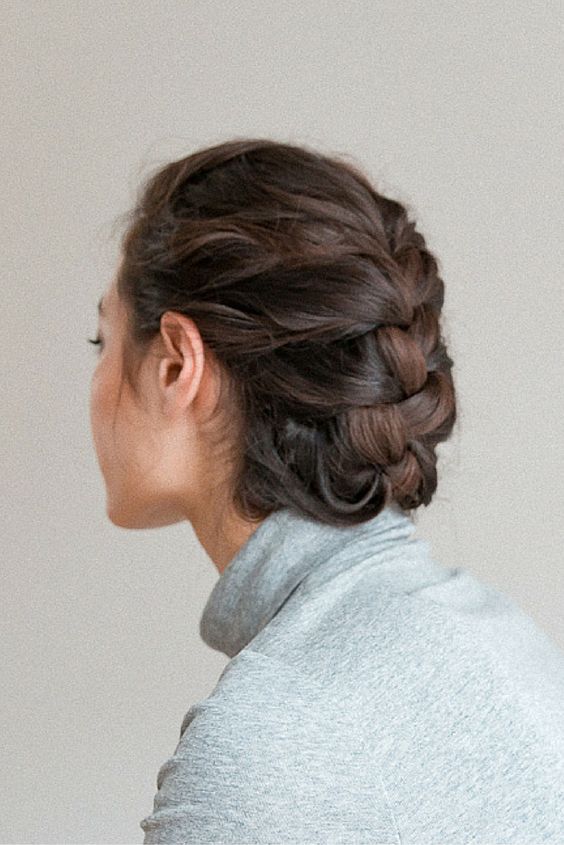 a simple braided low updo with a bump on top is a chic and catchy idea for a party look