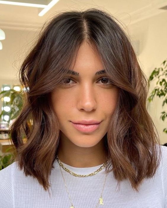a stylish chestnut brown long bob with waves and central parting is a catchy and chic idea to try right now