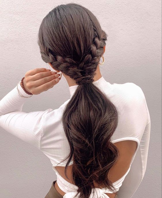 a stylish low wavy ponytail with a sleek top and two side braids is a cool and catchy solution
