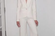 a stylish minimalist pantsuit with palazzo pants and a cutout blazer with long sleeves for a chic look