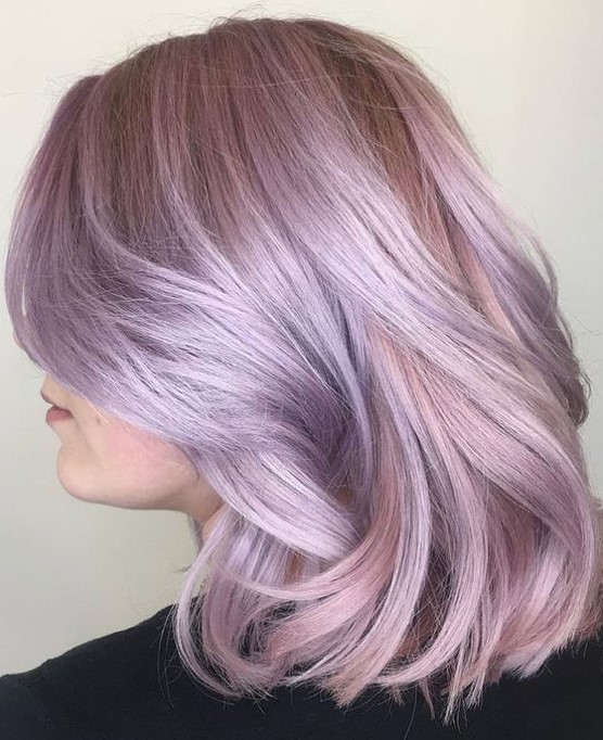 A subtle and chic lilac rose long bob with waves and face framing layers is very beautiful