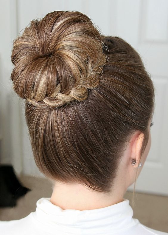 a top knot with a braid wrapping it and a volumetric top is a cool and catchy idea if you like knots and buns